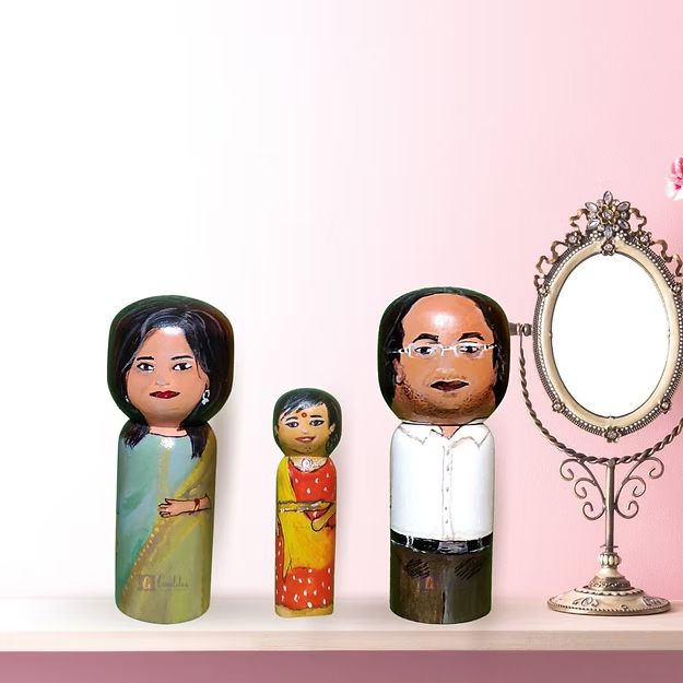A custom 3-pack personalized wooden family doll set displayed beautifully as minimalist nursery shelf home decor.