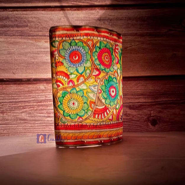A lit synthetic leather floral tea light holder sitting as a modern decorative centerpiece table runner accent.