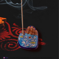 Light blue handcrafted pottery agarbatti incense stick holder with an integrated ceramic ash catching basin.