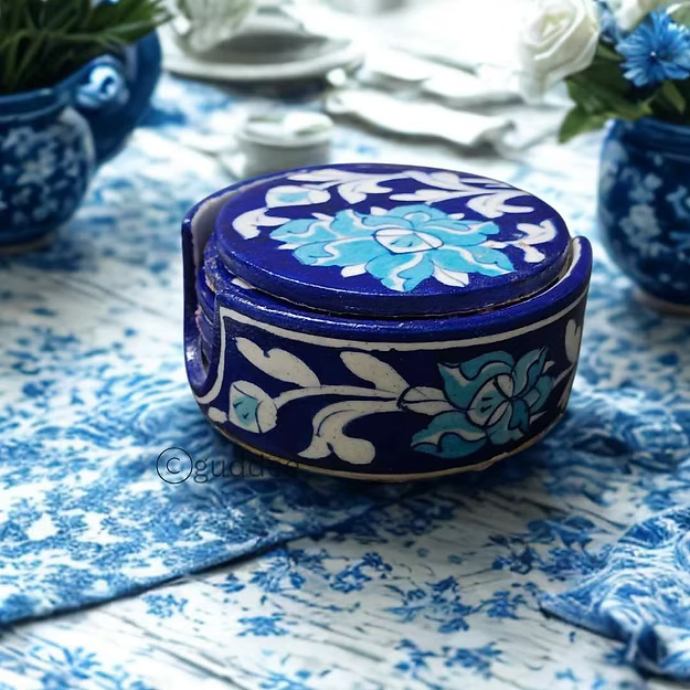 Close-up of the cobalt dark blue glaze and intricate floral brush patterns on an authentic clay-free quartz pottery coaster.