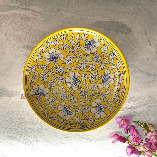 Light yellow handcrafted Jaipur yellow pottery wall plate featuring traditional hand-painted floral art mounted as home decor.