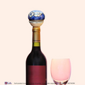 Blue Lagoon wine cork showing the vibrant hand-painted blue pottery circular floral details by Guddee.