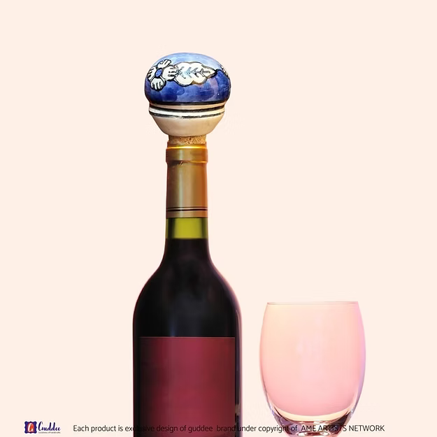 Blue Lagoon wine cork showing the vibrant hand-painted blue pottery circular floral details by Guddee.