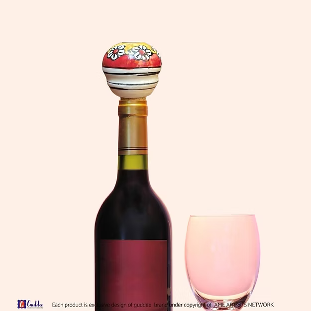 Red Yellow Drama wine cork showing the vibrant hand-painted blue pottery circular geometric details by Guddee.